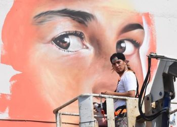 Venezuelalı sokak sanatçısı, Roman çocuklar için okul duvarını boyuyor